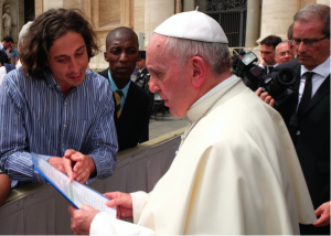 Pope Francis is informed about the Catholic Climate Petition by GCCM representatives (Tomás Insua from Argentina and Allen Ottaro from Kenya). Credit: Fotografia Felici