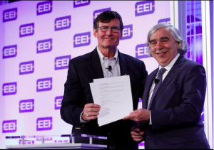 EEI President Tom Kuhn and Energy Secretary Moniz sign an MOU on electric vehicle adoption. — in New Orleans, Louisiana. Photo Credit: EEI