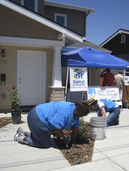 PG&E employee volunteers help to put in landscaping on a Habitat home equipped with solar panels in San Luis Obispo, Calif.