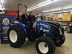 Bill and Katherine Howell take a seat in their new New Holland Boomer 47 as part of the 2015 Growth Energy Individual Member Sweepstakes. Photo Credit: Carroll Broadcasting Company.